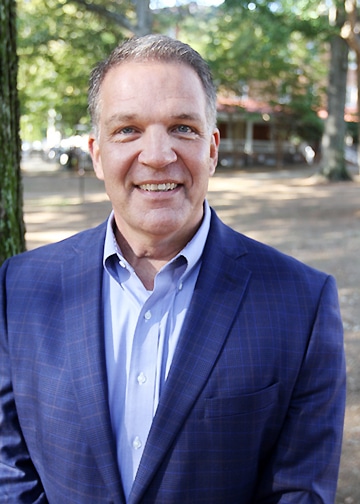 John Alford, GreenServ Founder, posing for a picture outside.